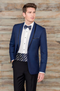 Man in blue tuxedo with bow tie.