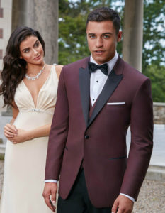 Man in burgundy tuxedo with woman.