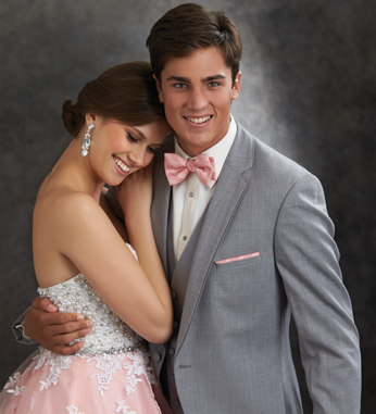 Couple in prom attire embracing.