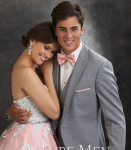 Couple in prom attire, he in gray suit.