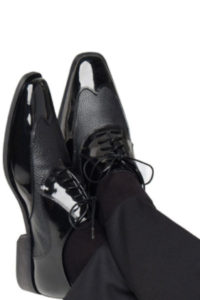 Black leather shoes on formal trousers.