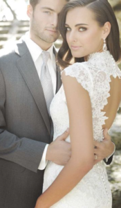 Bride and groom embracing outdoors.