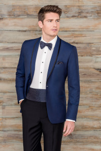 Here's an alt tag for the image: Man in navy tuxedo, bow tie.