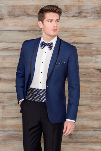 Man in blue tuxedo, patterned bow tie.