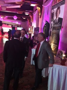 Men in suits at a tuxedo display.