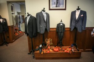 Men's suits displayed on mannequins.