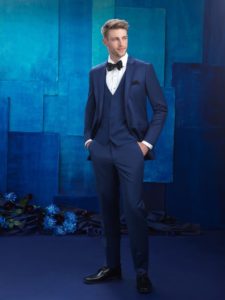 Man in blue tuxedo, black bow tie.