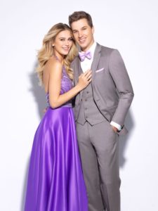 Couple in prom attire; he in gray, she in purple.