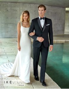 Elegant couple in wedding attire by Ike Behar.