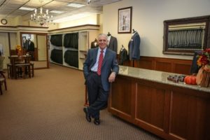 Man in suit at a men's clothing store.