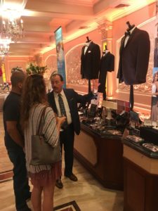 Man showing tuxedo options at wedding expo.
