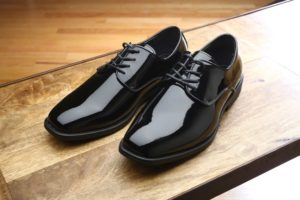 Pair of black patent leather shoes.