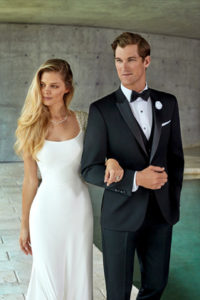 Elegant bride and groom in wedding attire.