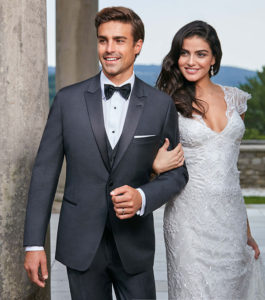 Groom in tuxedo with bride in wedding dress.