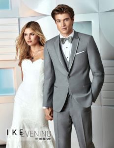Groom in gray suit with bride.