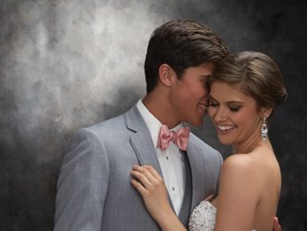 Couple in prom attire embracing.
