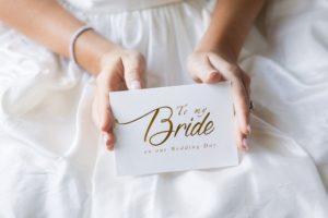 Bride holding wedding day message.