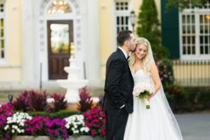 Groom kissing bride on wedding day.