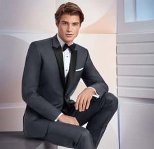 Man in charcoal tuxedo, black bow tie.