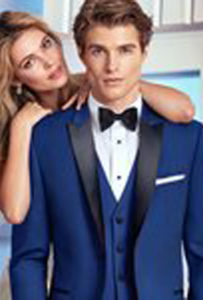 Man in blue tuxedo with woman.