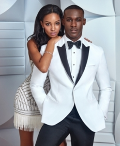Couple in formal wear; he in white tuxedo.