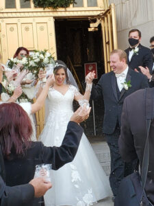 Happy bride and groom exiting church.