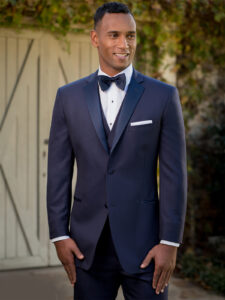 Man in navy tuxedo, bow tie.