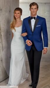 Couple in wedding attire; he's in a blue tuxedo.