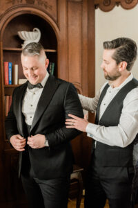 Groom getting ready in tuxedo.