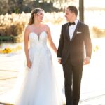 Happy bride and groom holding hands.