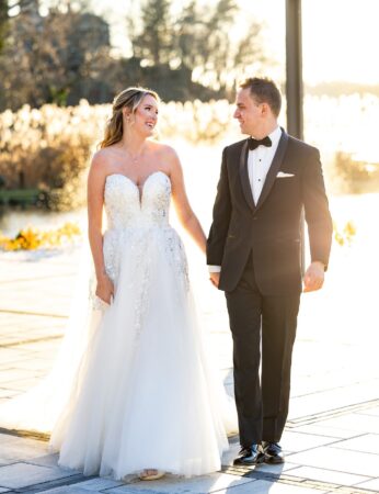 Happy bride and groom holding hands.