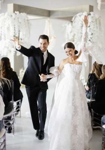 Happy newlyweds exiting wedding ceremony.