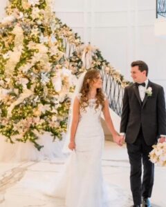 Bride and groom by Christmas tree.