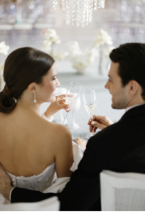 Bride and groom toasting champagne.